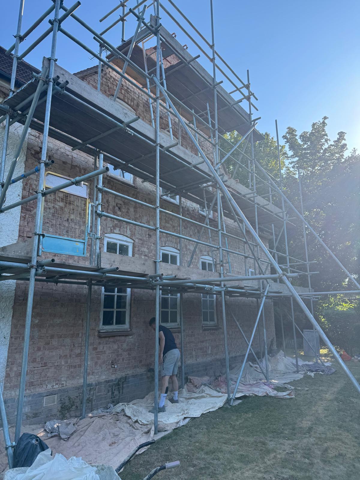 Pebble dashing project in Letchworth on a residential property with scaffolding across the exterior.