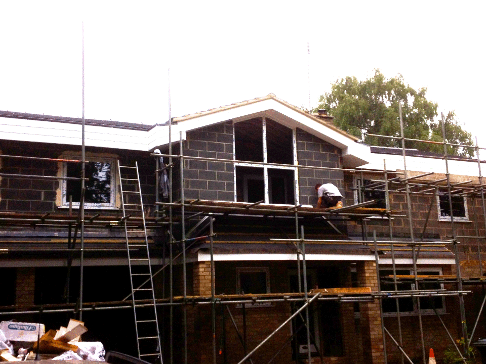Two-coat Weber monocouche render project in Pavenham with scaffolding around a residential property during preparation works.